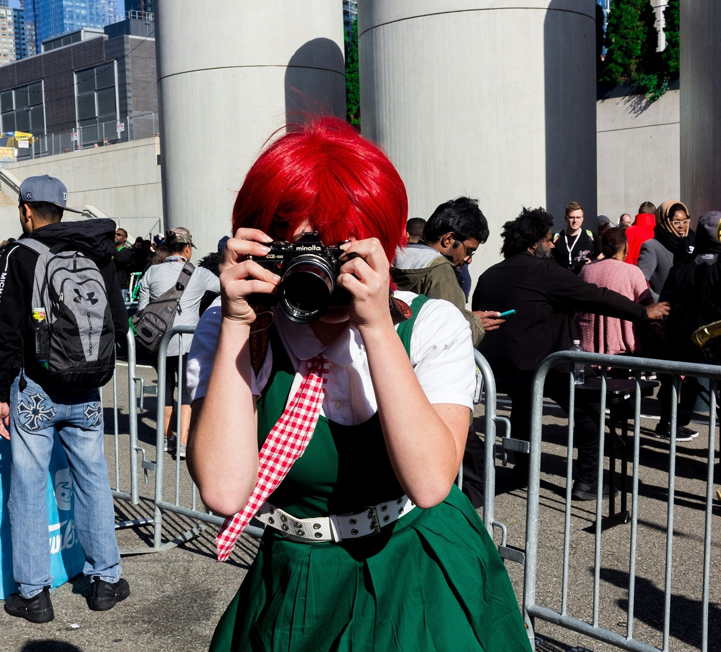 cosplayer-red-hair-green-dress-camera.jpg cosplayer with red hair, a green dress, and a camera