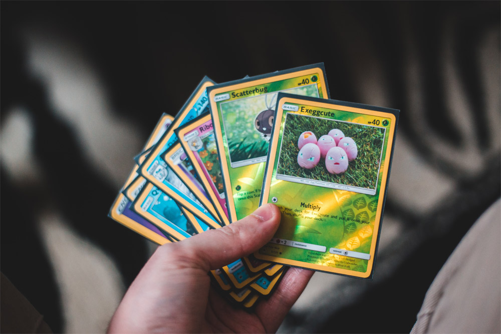 a hand holding trading cards a hand holding trading cards