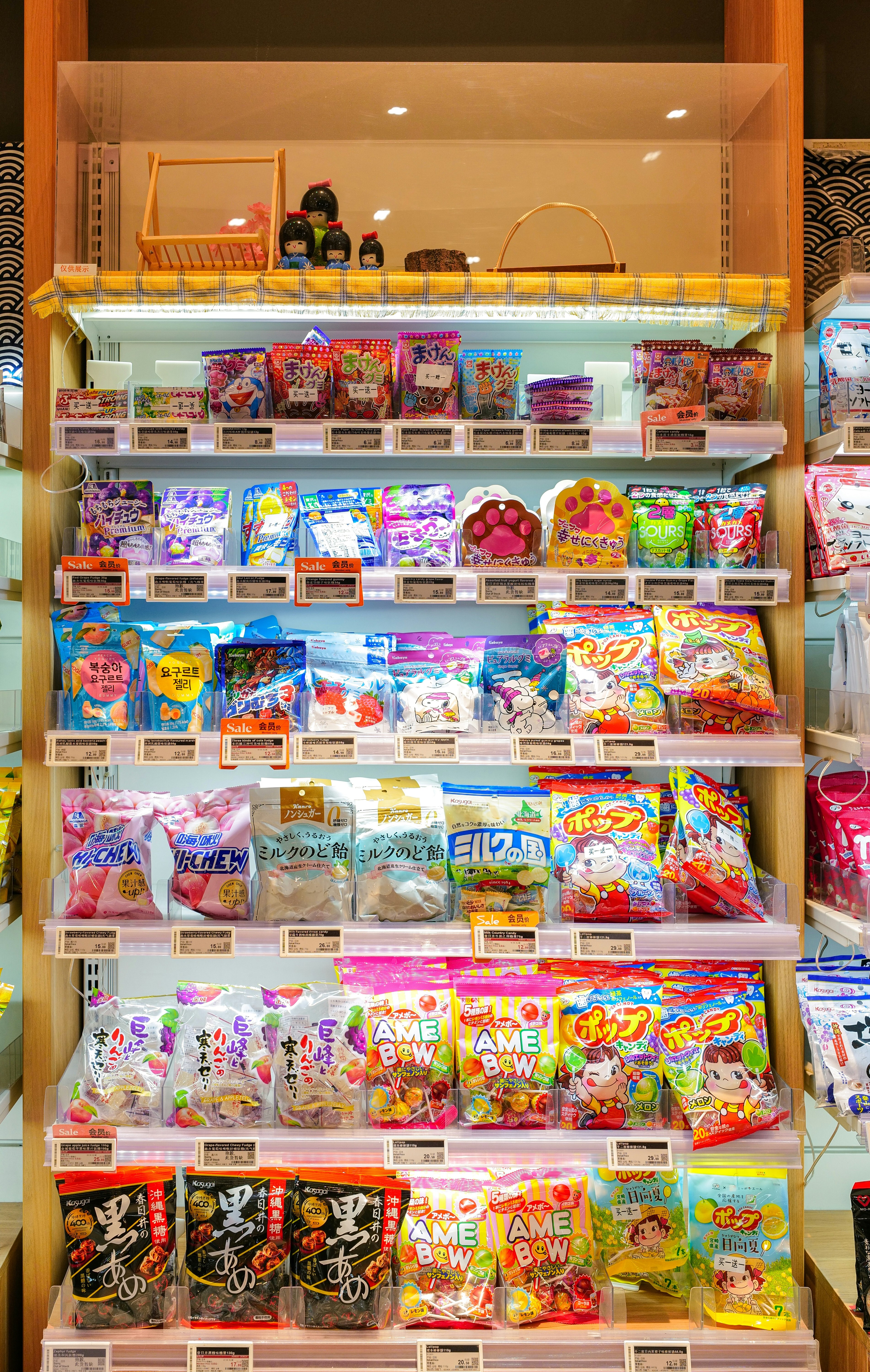 A well-lit shelf displaying Japanese candies and snacks