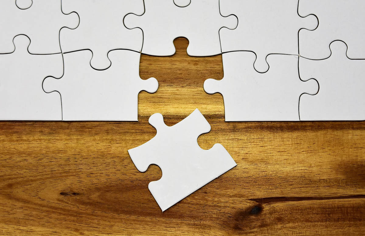 last puzzle piece joining puzzle on wood table last puzzle piece joining puzzle on wood table