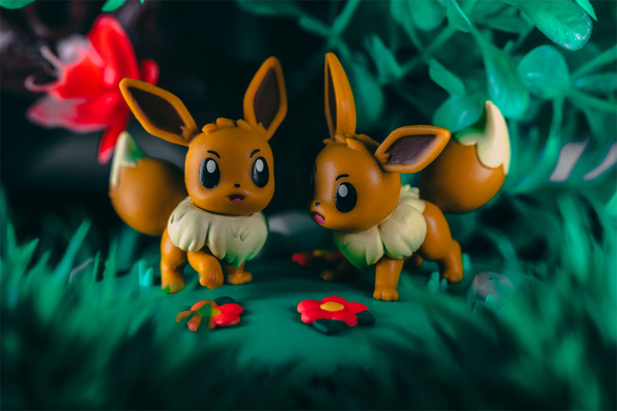 two small Pokemon toys in fake grass two small Pokemon toys in fake grass